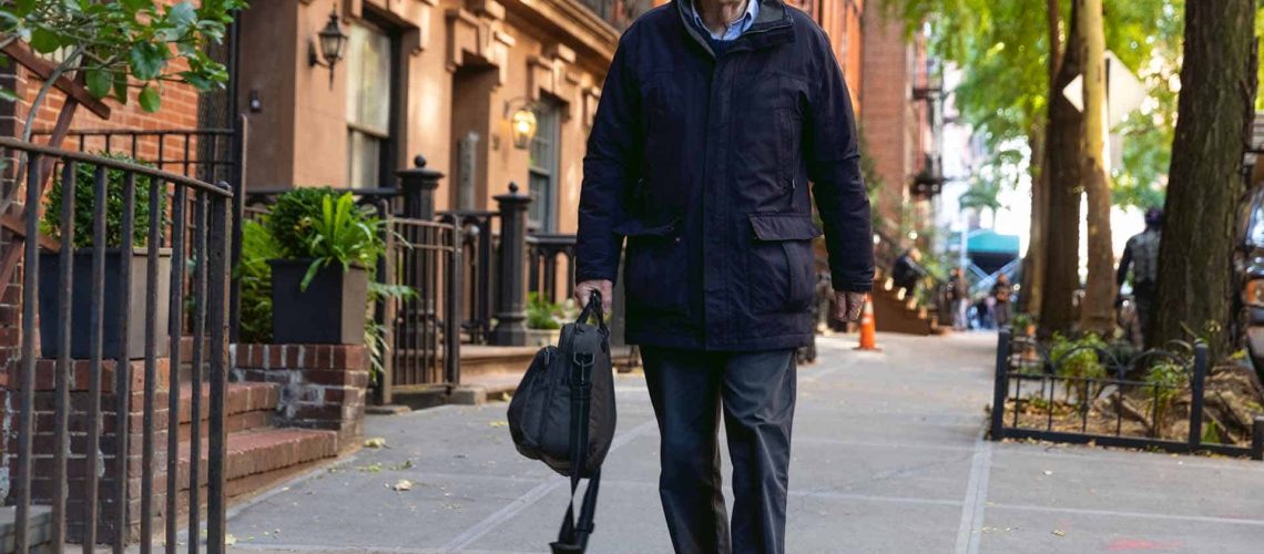 image of elderly man walking on sidewalk